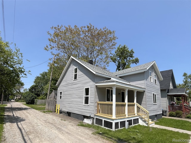 1015 9th St, Port Huron, MI 48060 - view of side of home with a porch and roof with shingles