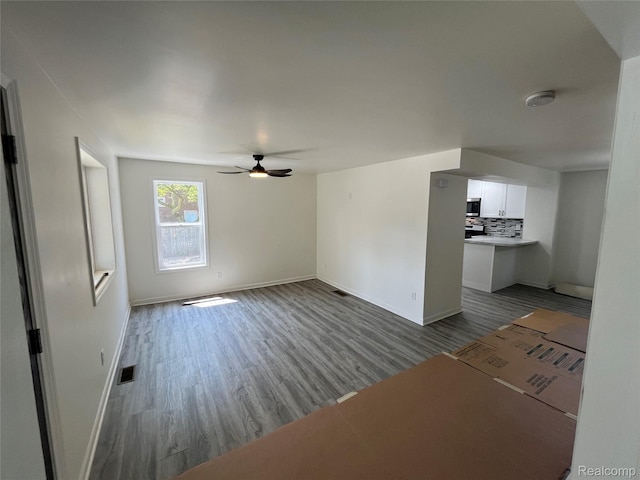 1015 9th St, Port Huron, MI 48060 - unfurnished living room featuring dark wood-type flooring and a ceiling fan