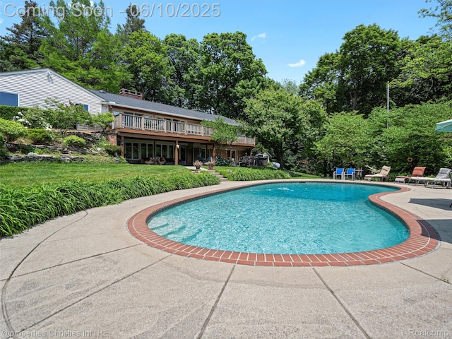 4383 Pine Tree Trl, Bloomfield Hills, MI 48302 - outdoor pool with a patio, a lawn, view of scattered trees, and a deck