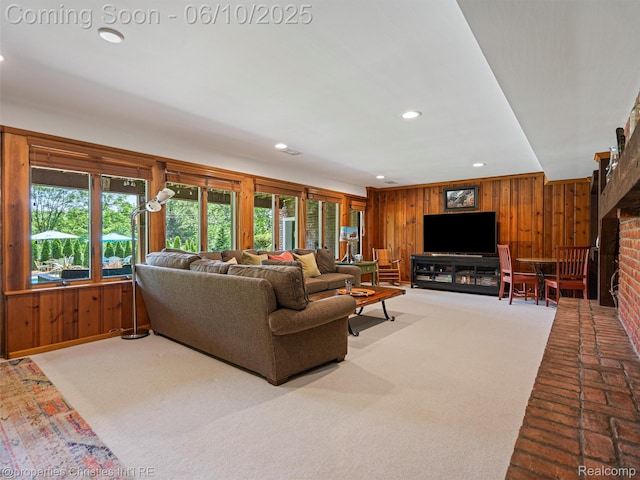 4383 Pine Tree Trl, Bloomfield Hills, MI 48302 - living room featuring wooden walls, recessed lighting, a brick fireplace, and carpet flooring
