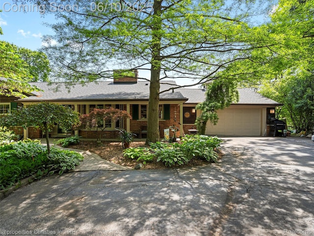 4383 Pine Tree Trl, Bloomfield Hills, MI 48302 - ranch-style house featuring an attached garage, driveway, a chimney, roof with shingles, and brick siding