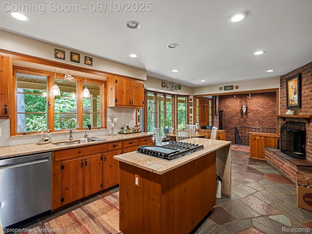 4383 Pine Tree Trl, Bloomfield Hills, MI 48302 - kitchen with stainless steel appliances, a sink, a fireplace, recessed lighting, and brick wall