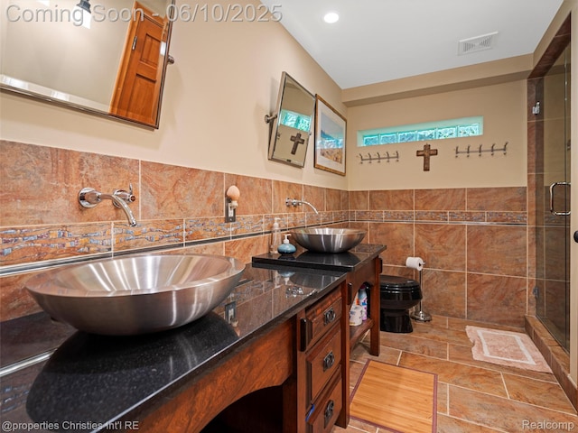 4383 Pine Tree Trl, Bloomfield Hills, MI 48302 - full bath with tile walls, double vanity, a shower stall, and a wainscoted wall