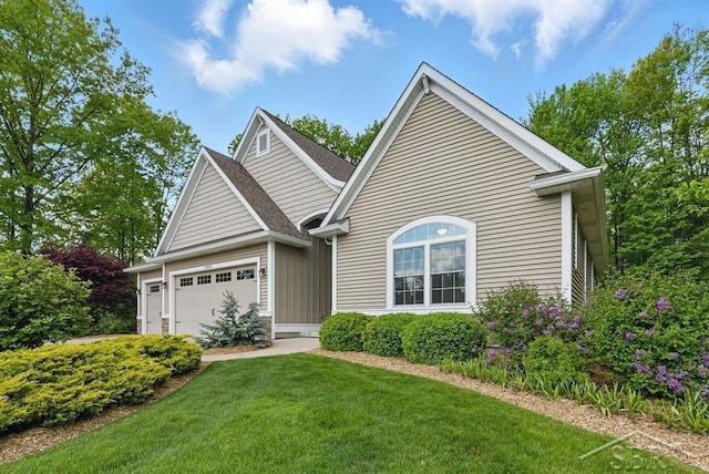 2887 E Iron Woods Pass, Midland, MI 48642 - view of front facade with an attached garage, a front lawn, and board and batten siding