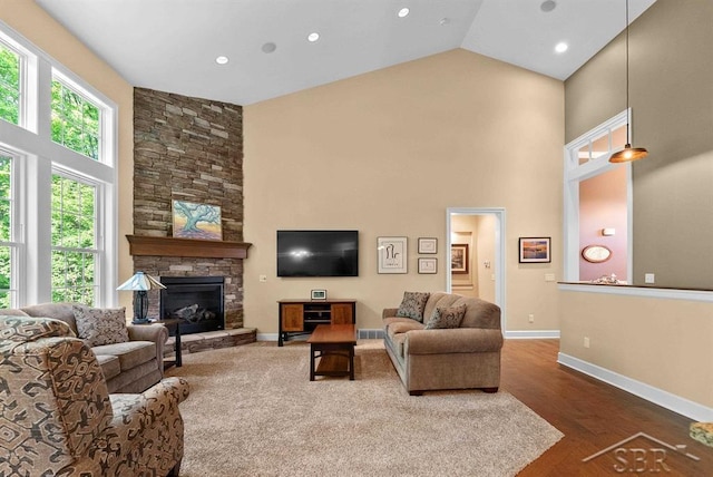 2887 E Iron Woods Pass, Midland, MI 48642 - living room with high vaulted ceiling, baseboards, wood finished floors, a fireplace, and recessed lighting