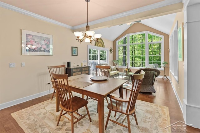 2887 E Iron Woods Pass, Midland, MI 48642 - dining space with wood finished floors, a chandelier, vaulted ceiling, baseboards, and crown molding