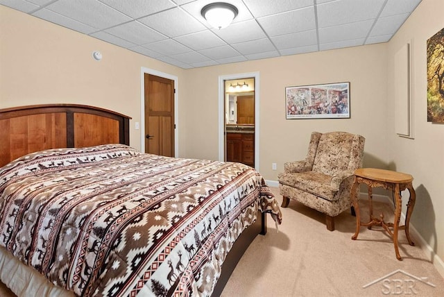 2887 E Iron Woods Pass, Midland, MI 48642 - carpeted bedroom featuring a paneled ceiling, baseboards, and ensuite bath