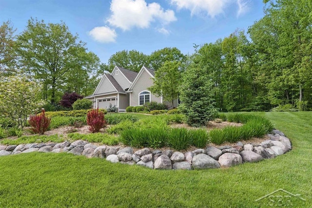 2887 E Iron Woods Pass, Midland, MI 48642 - view of front of home with an attached garage and a front lawn