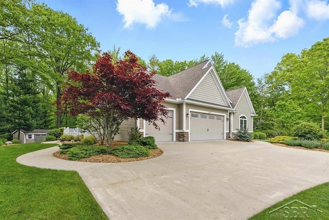 2887 E Iron Woods Pass, Midland, MI 48642 - view of front of property with a garage, driveway, a front yard, stone siding, and a shingled roof