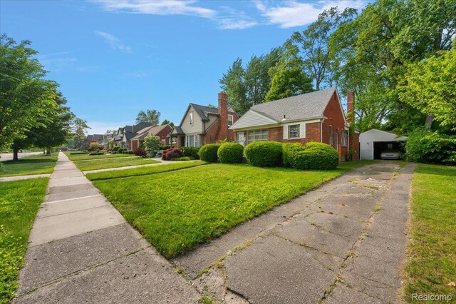 2829 Dorchester Rd, Birmingham, MI 48009 - view of side of home featuring an outdoor structure, a lawn, brick siding, a garage, and a residential view