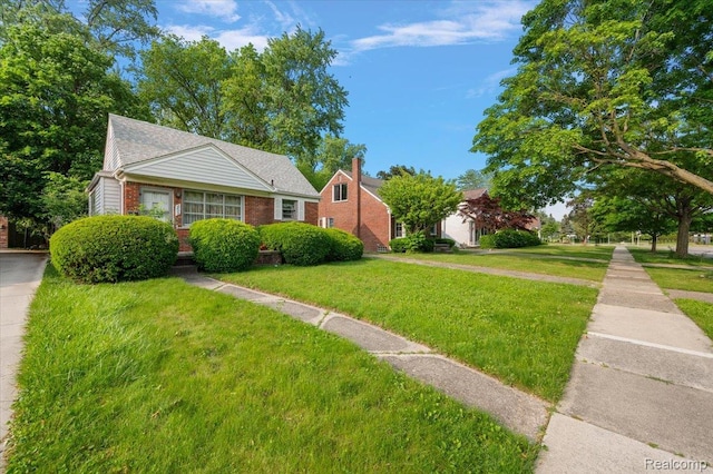 2829 Dorchester Rd, Birmingham, MI 48009 - bungalow-style house with a front lawn and brick siding