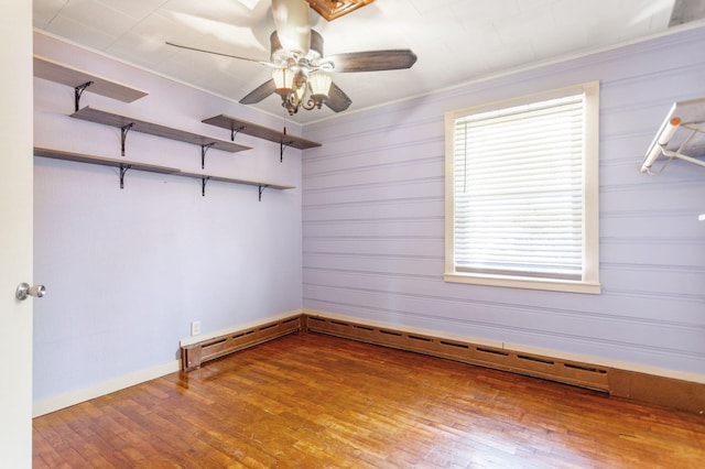 74219 Lambert Dr, South Haven, MI 49090 - empty room with hardwood / wood-style flooring, ceiling fan, ornamental molding, baseboards, and a baseboard heating unit