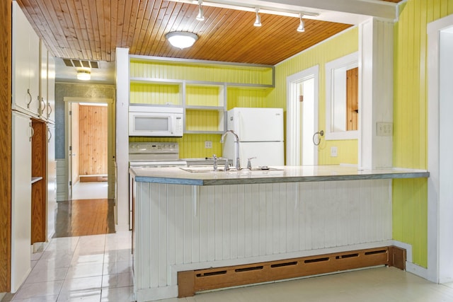 74219 Lambert Dr, South Haven, MI 49090 - kitchen with white appliances, a sink, rail lighting, wooden ceiling, and a peninsula