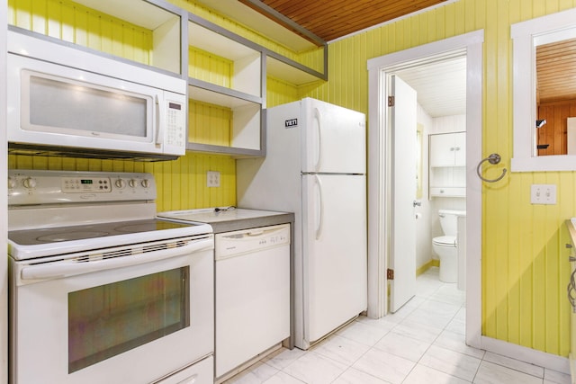 74219 Lambert Dr, South Haven, MI 49090 - kitchen with white appliances, open shelves, wooden walls, light countertops, and light tile patterned floors