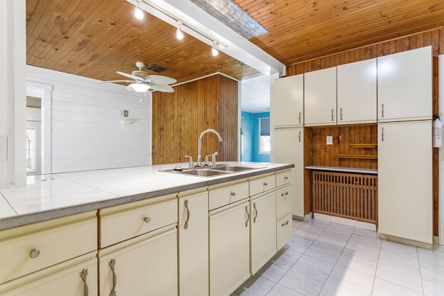 74219 Lambert Dr, South Haven, MI 49090 - kitchen with a sink, wooden walls, wooden ceiling, light countertops, and a ceiling fan