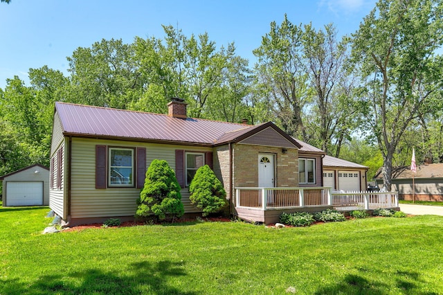 74219 Lambert Dr, South Haven, MI 49090 - view of front of property with a chimney, a garage, a front yard, and metal roof