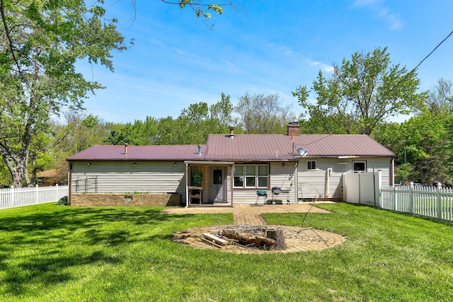 74219 Lambert Dr, South Haven, MI 49090 - rear view of house with a fire pit, metal roof, and a chimney