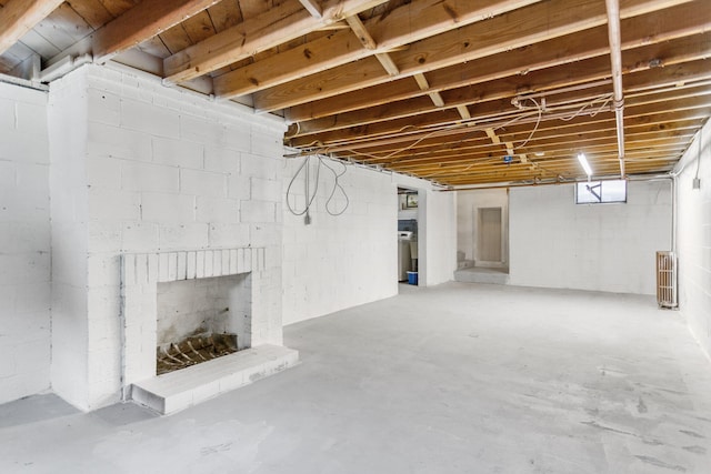 74219 Lambert Dr, South Haven, MI 49090 - unfinished basement featuring a fireplace and radiator heating unit