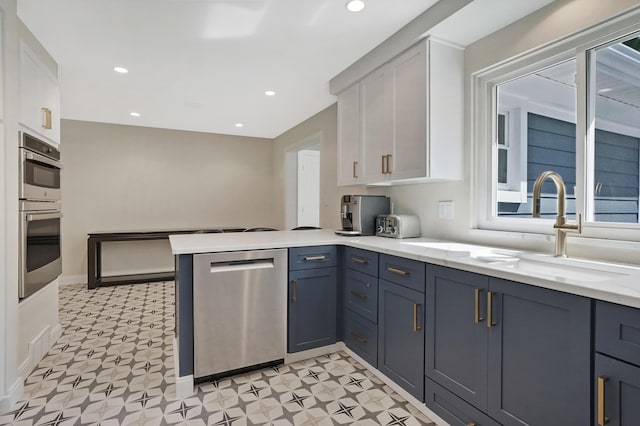 660 Sylvanwood Dr, Troy, MI 48085 - kitchen featuring appliances with stainless steel finishes, light floors, white cabinetry, a peninsula, and recessed lighting