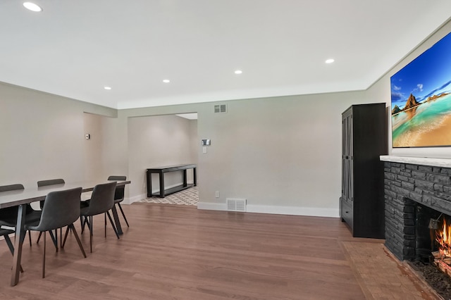 660 Sylvanwood Dr, Troy, MI 48085 - dining space featuring a fireplace, wood finished floors, recessed lighting, and baseboards