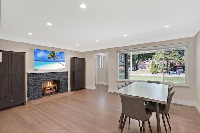660 Sylvanwood Dr, Troy, MI 48085 - dining area featuring baseboards, light wood-type flooring, a stone fireplace, and recessed lighting
