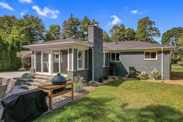660 Sylvanwood Dr, Troy, MI 48085 - rear view of property with a sunroom, a lawn, a chimney, and brick siding
