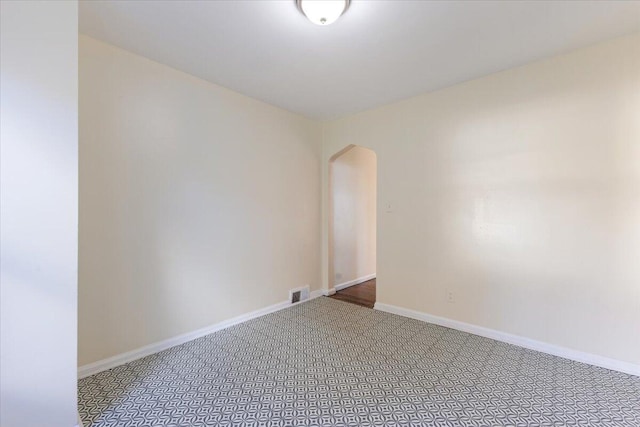 504 Alter Rd, Detroit, MI 48215 - empty room featuring arched walkways, carpet, and baseboards