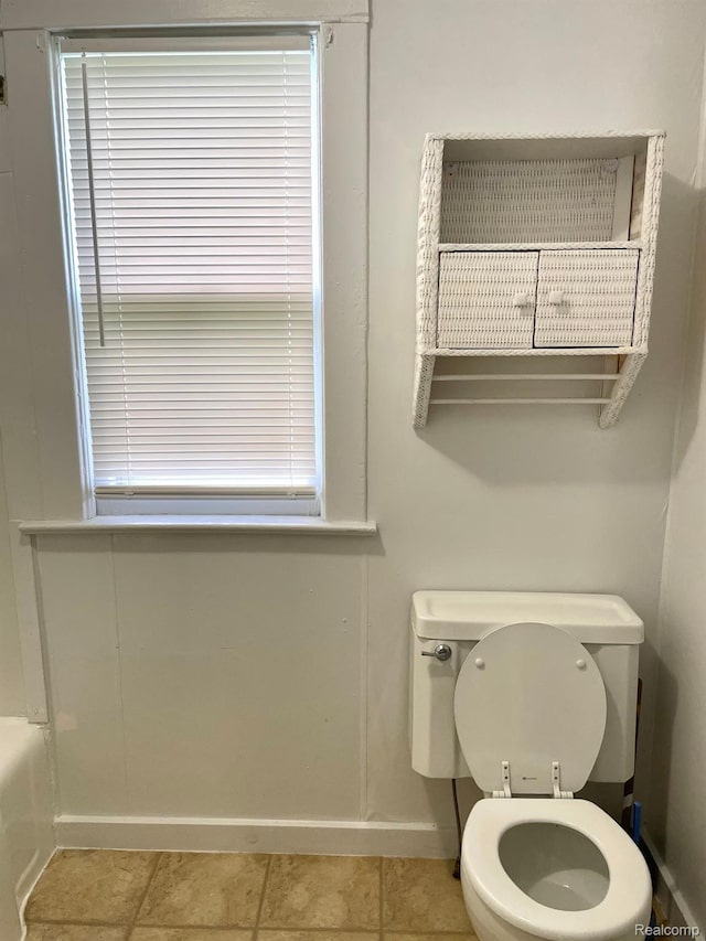 2373 S Dye Rd, Flint, MI 48532 - bathroom with toilet, a tub, baseboards, and tile patterned flooring