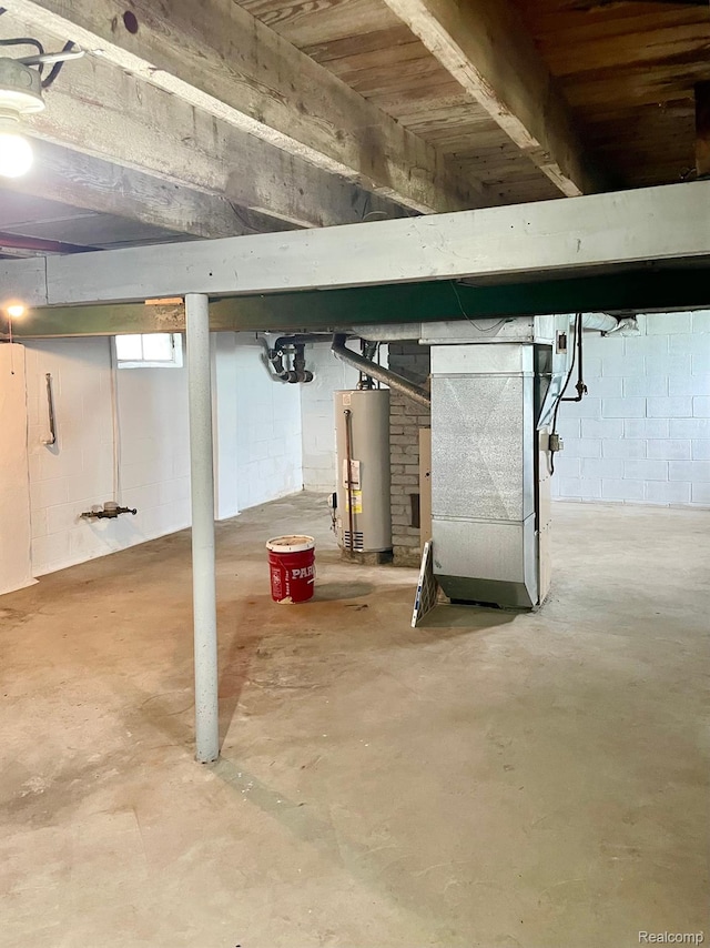 2373 S Dye Rd, Flint, MI 48532 - basement with gas water heater, heating unit, and concrete block wall