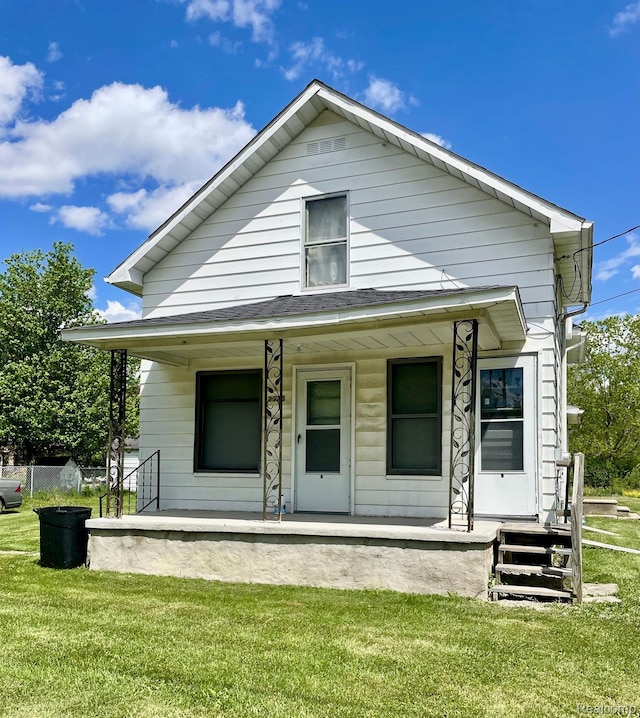2373 S Dye Rd, Flint, MI 48532 - view of front of house with covered porch and a front lawn