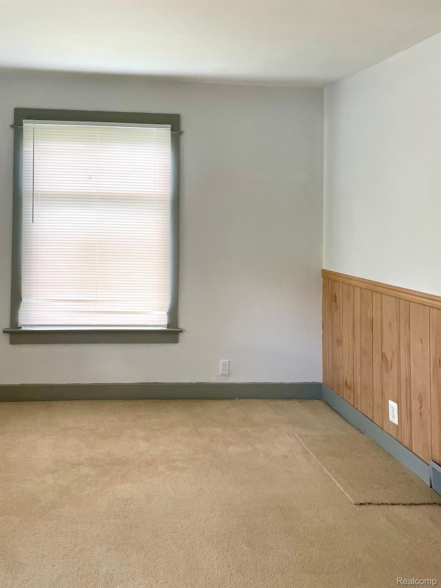 2373 S Dye Rd, Flint, MI 48532 - unfurnished room featuring carpet floors, wainscoting, wooden walls, and baseboards