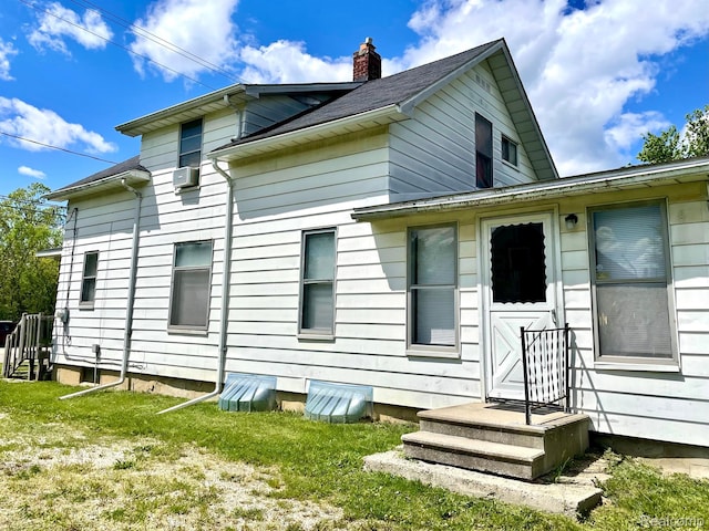 2373 S Dye Rd, Flint, MI 48532 - back of house featuring a chimney and a yard