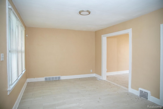 6052 Hartford St, Detroit, MI 48210 - unfurnished room featuring healthy amount of natural light, baseboards, and light wood finished floors