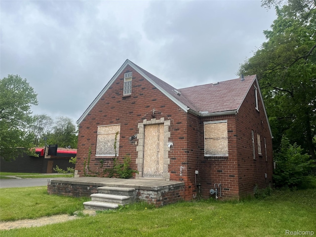 9803 Nottingham Rd, Detroit, MI 48224 - english style home with brick siding, a front yard, and roof with shingles