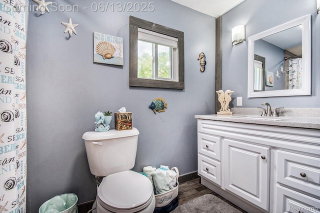 8515 Old State Ave, Farwell, MI 48622 - bathroom with vanity, wood finished floors, baseboards, and toilet