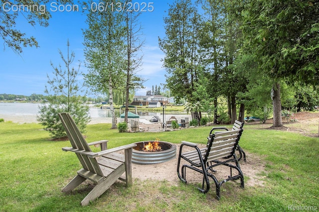 8515 Old State Ave, Farwell, MI 48622 - view of grassy yard featuring an outdoor fire pit and a water view
