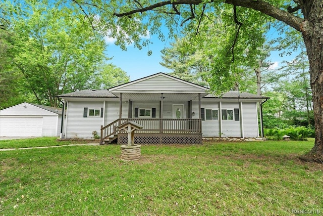 1060 Apple Blossom Dr, Howell, MI 48843 - single story home with an outbuilding, a garage, a front yard, and covered porch