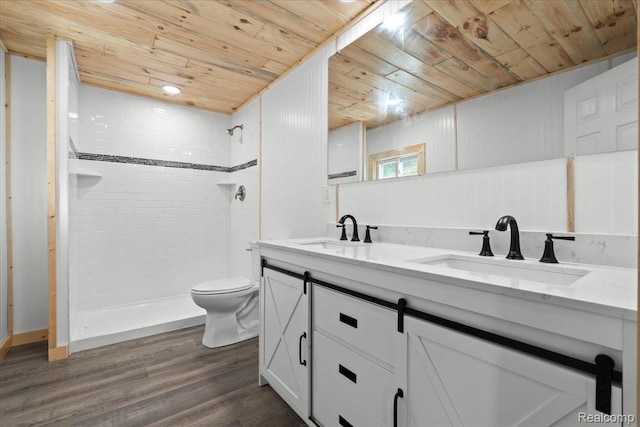 1060 Apple Blossom Dr, Howell, MI 48843 - bathroom with wood ceiling, double vanity, toilet, wood finished floors, and a tile shower