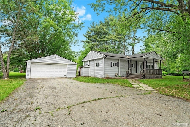 1060 Apple Blossom Dr, Howell, MI 48843 - ranch-style home featuring covered porch, an outdoor structure, a garage, and a front yard