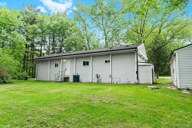 1060 Apple Blossom Dr, Howell, MI 48843 - back of house with entry steps and a lawn