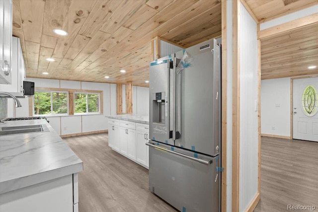 1060 Apple Blossom Dr, Howell, MI 48843 - kitchen featuring high quality fridge, wooden ceiling, light wood-style floors, white cabinetry, and baseboards