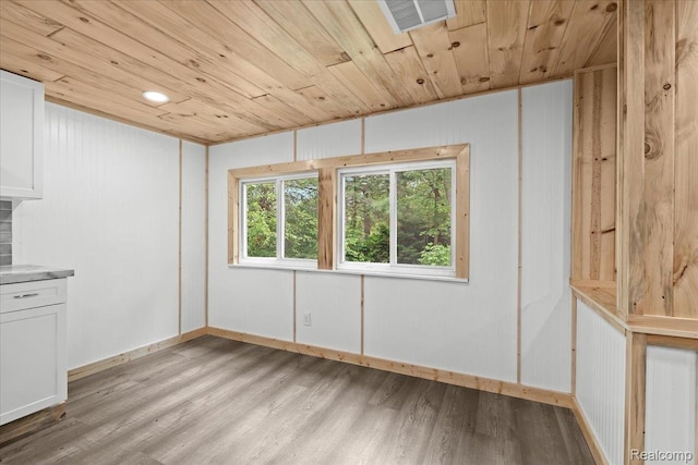 1060 Apple Blossom Dr, Howell, MI 48843 - unfurnished dining area featuring wood ceiling, light wood finished floors, and baseboards