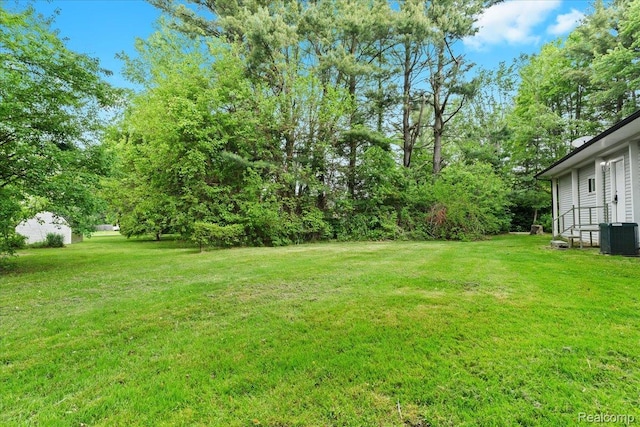 1060 Apple Blossom Dr, Howell, MI 48843 - view of green lawn featuring cooling unit