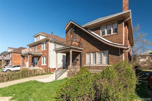 46 W Arizona St, Highland Park, MI 48203 - traditional-style house with a balcony, brick siding, and a chimney