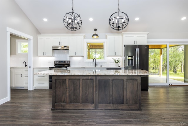 2291 E Maple Rd, Clare, MI 48617 - kitchen with under cabinet range hood, a chandelier, a center island, black electric range oven, and backsplash