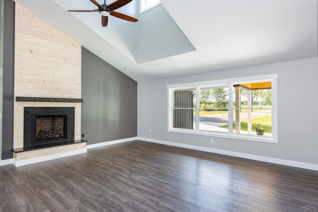 2291 E Maple Rd, Clare, MI 48617 - unfurnished living room featuring ceiling fan, dark wood-style flooring, baseboards, and high vaulted ceiling