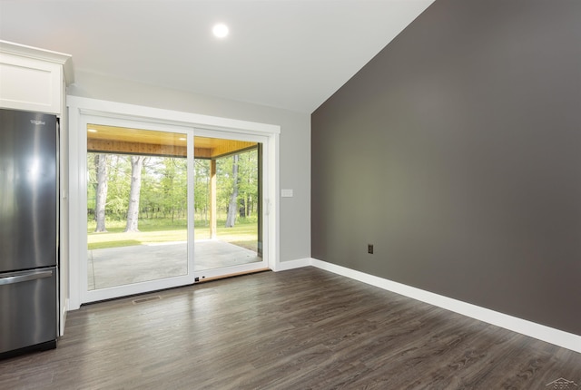 2291 E Maple Rd, Clare, MI 48617 - empty room with dark wood-type flooring, baseboards, vaulted ceiling, and recessed lighting