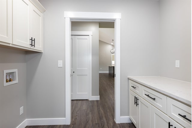 2291 E Maple Rd, Clare, MI 48617 - laundry area with cabinet space, washer hookup, and dark wood-style floors