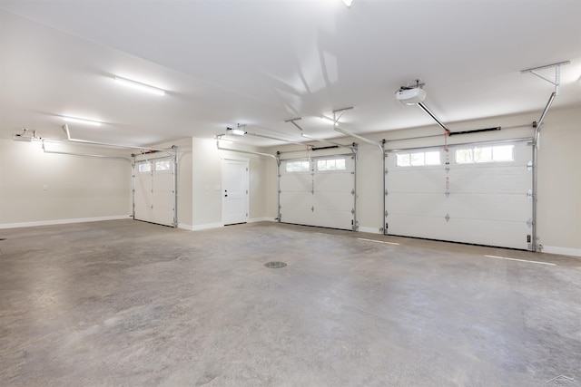 2291 E Maple Rd, Clare, MI 48617 - garage with a garage door opener and baseboards