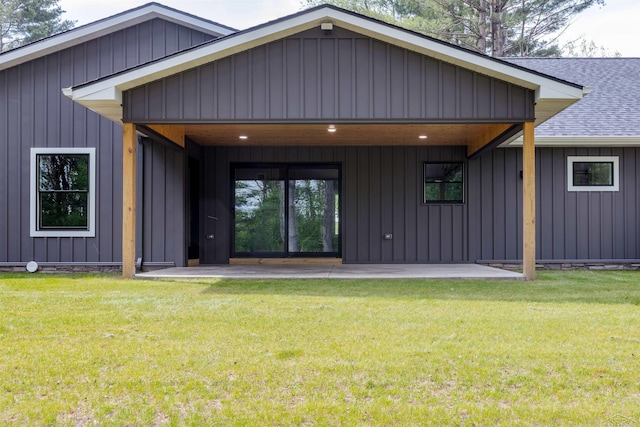 2291 E Maple Rd, Clare, MI 48617 - back of house featuring roof with shingles, a yard, and board and batten siding
